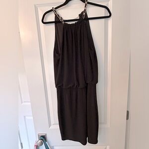 LAUNDRY black jersey halter top dress with gold chain necklace accent.